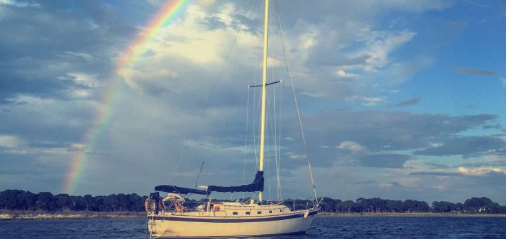 sailboat under rainbow